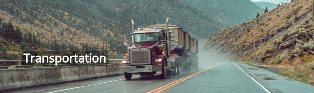 a truck driving down a mountain road