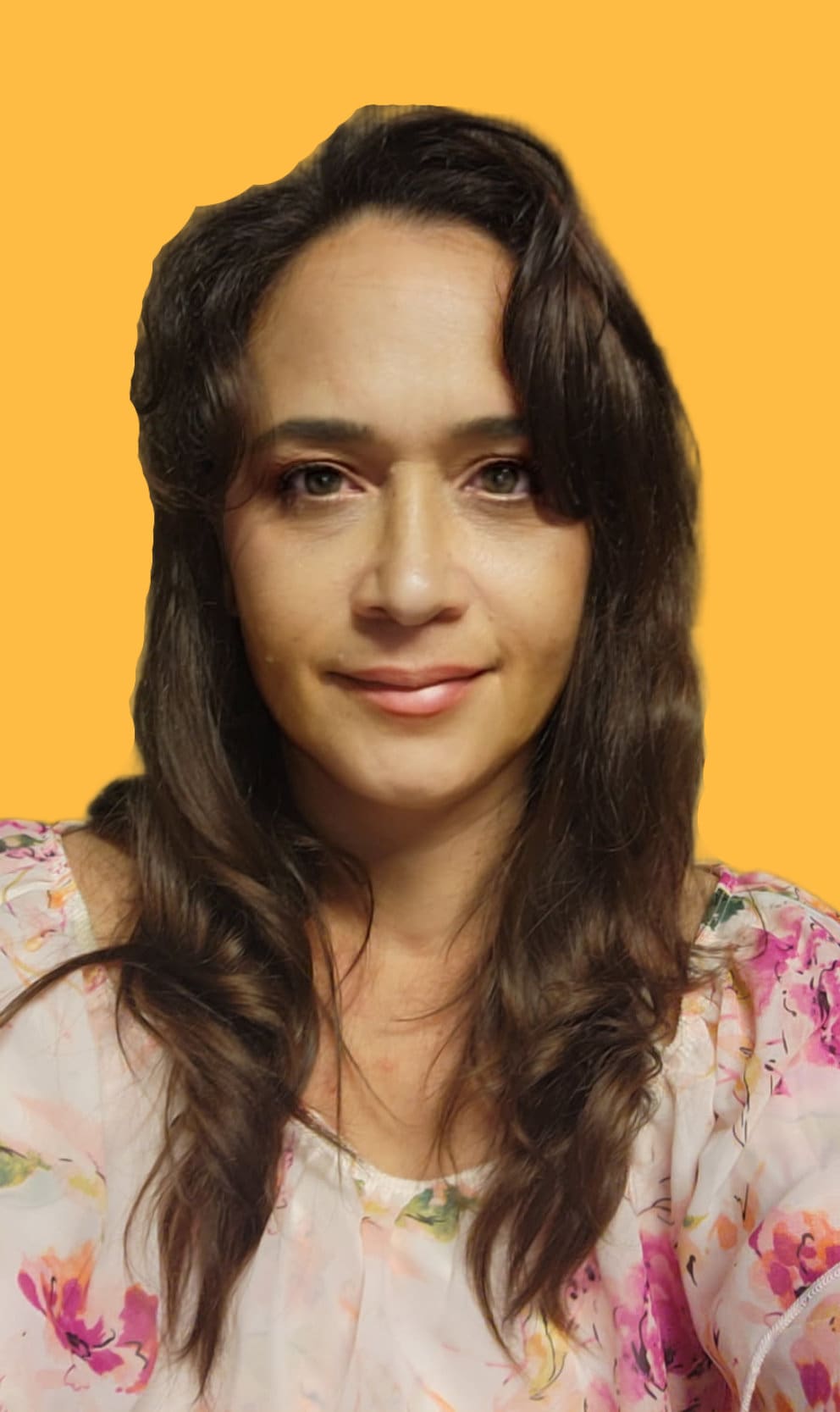 Portrait photo of a woman with long wavy brown hair, wearing a light floral top, smiling slightly against a solid yellow background.
