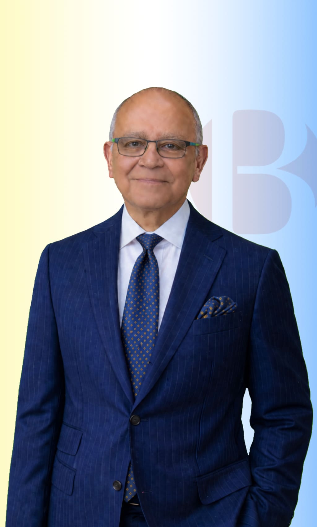 Juan Jose De La Cruz wearing a blue pinstripe suit and glasses, insurance professional at Best Formula Insurance